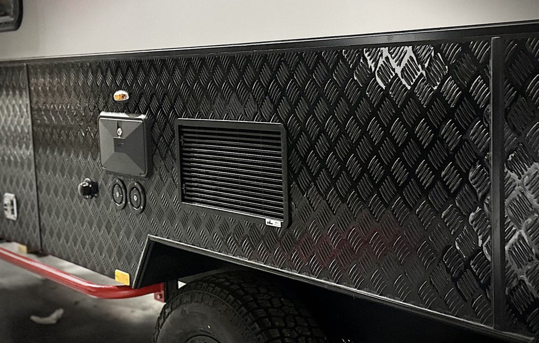 diamond plate body panel on the lower side of an HQ camper