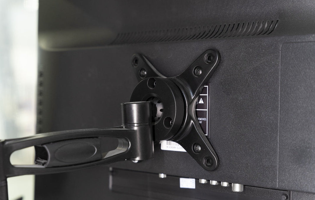 Television secured on a wall mount bracket inside an RV