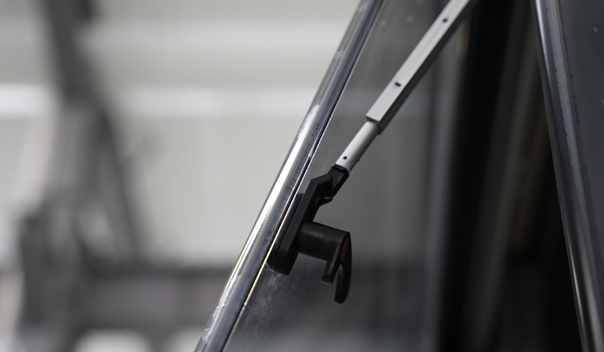 Gas lift strut supporting an open dual pane RV window