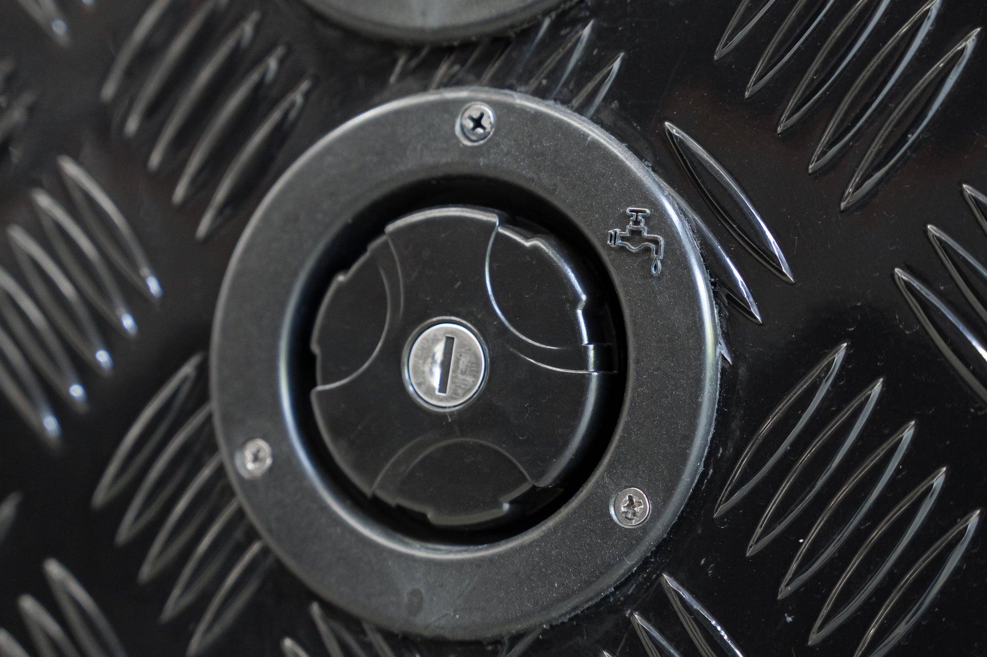 Black Series OEM water inlet with keyed locking cap, angled view on camper