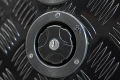 Black Series OEM water inlet with keyed locking cap, angled view on camper