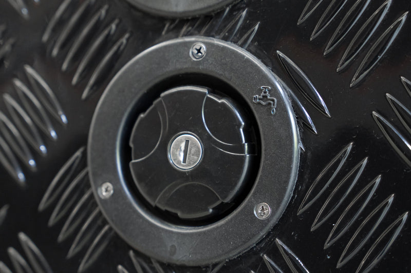 Black Series OEM water inlet with keyed locking cap, angled view on camper