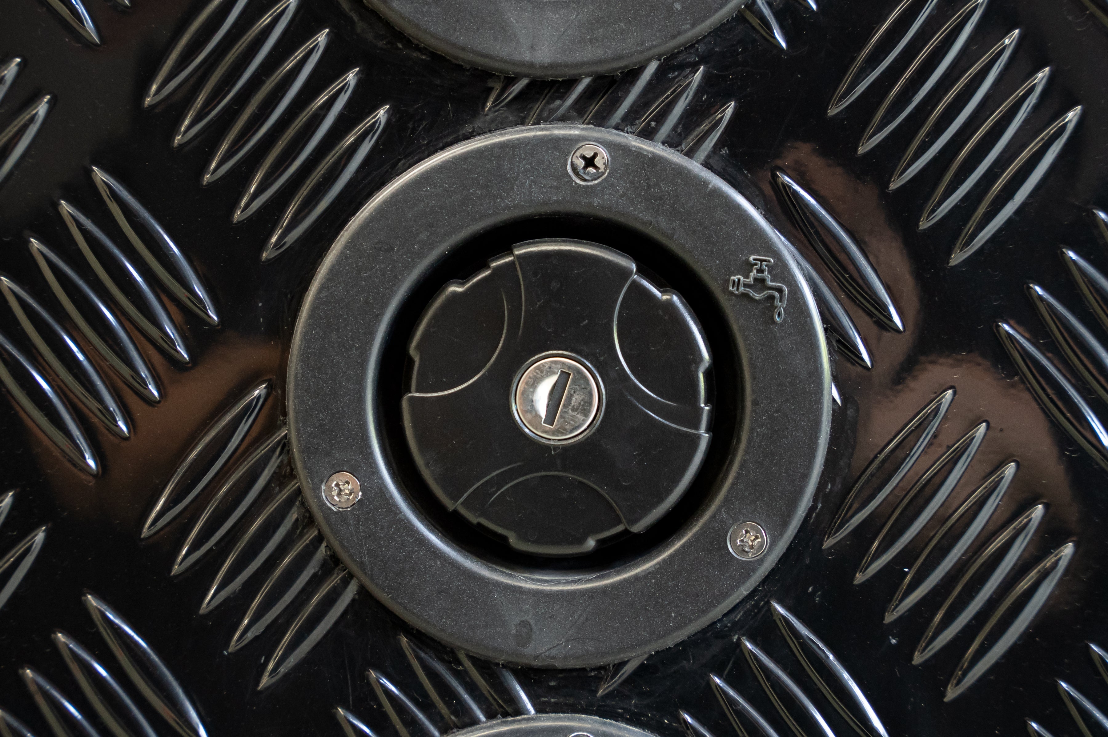 Black Series OEM water inlet installed on checker plate camper panel