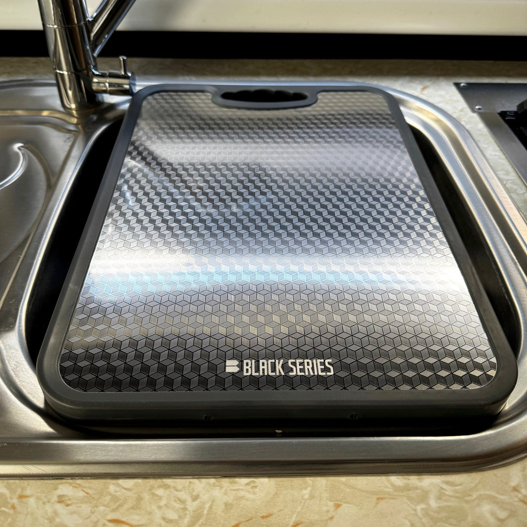 Black Series RV stainless sink cover cutting board fitted in a camper kitchen sink