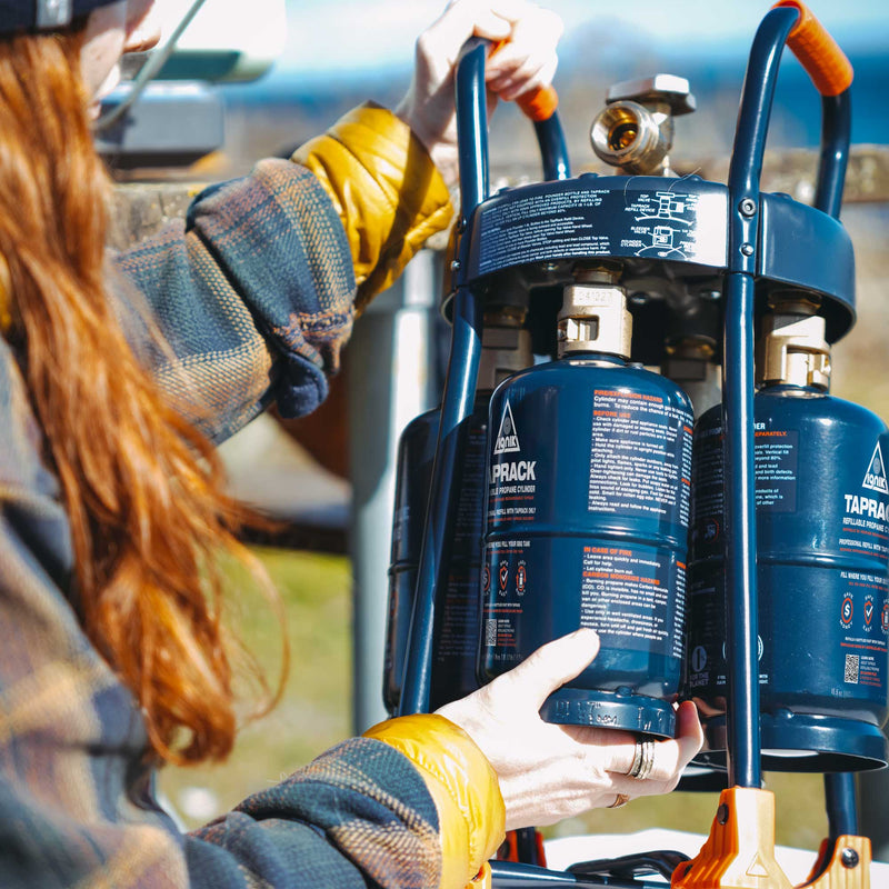 Ignik TapRack refilling device with four blue refillable propane bottles