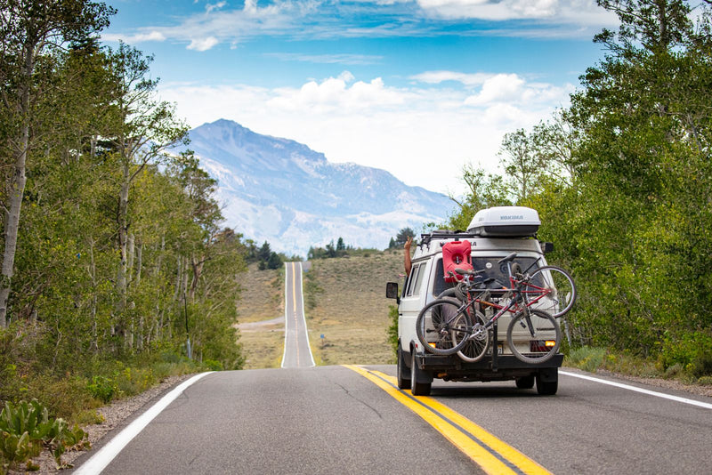 Camper van on a mountain road covered by the Adventure Care Plan