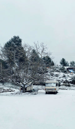 Motorhome parked in snow, prepared for winterization service