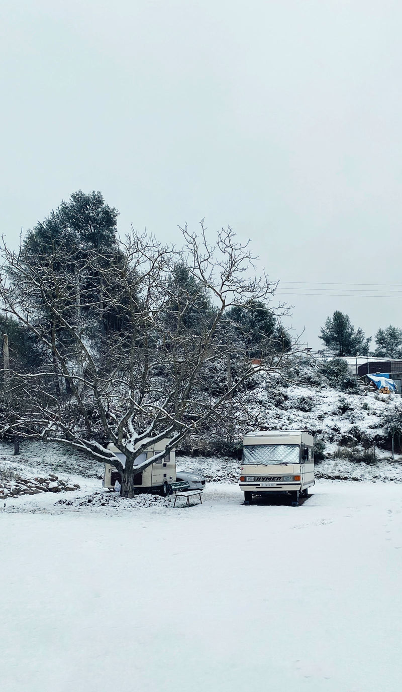 Motorhome parked in snow, prepared for winterization service